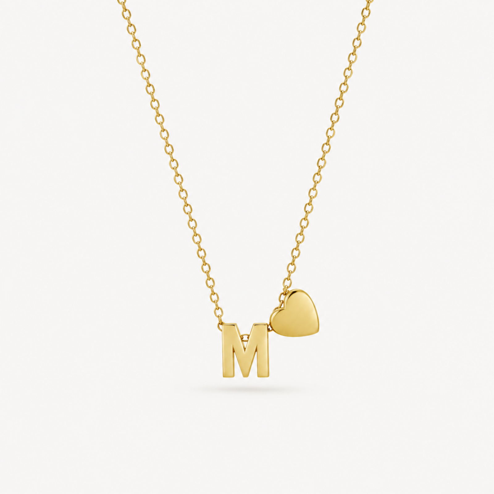 anvor-m-initial-necklace-heart-pendant.webp ANVOR M initial necklace with gold-tone letter M and heart pendant