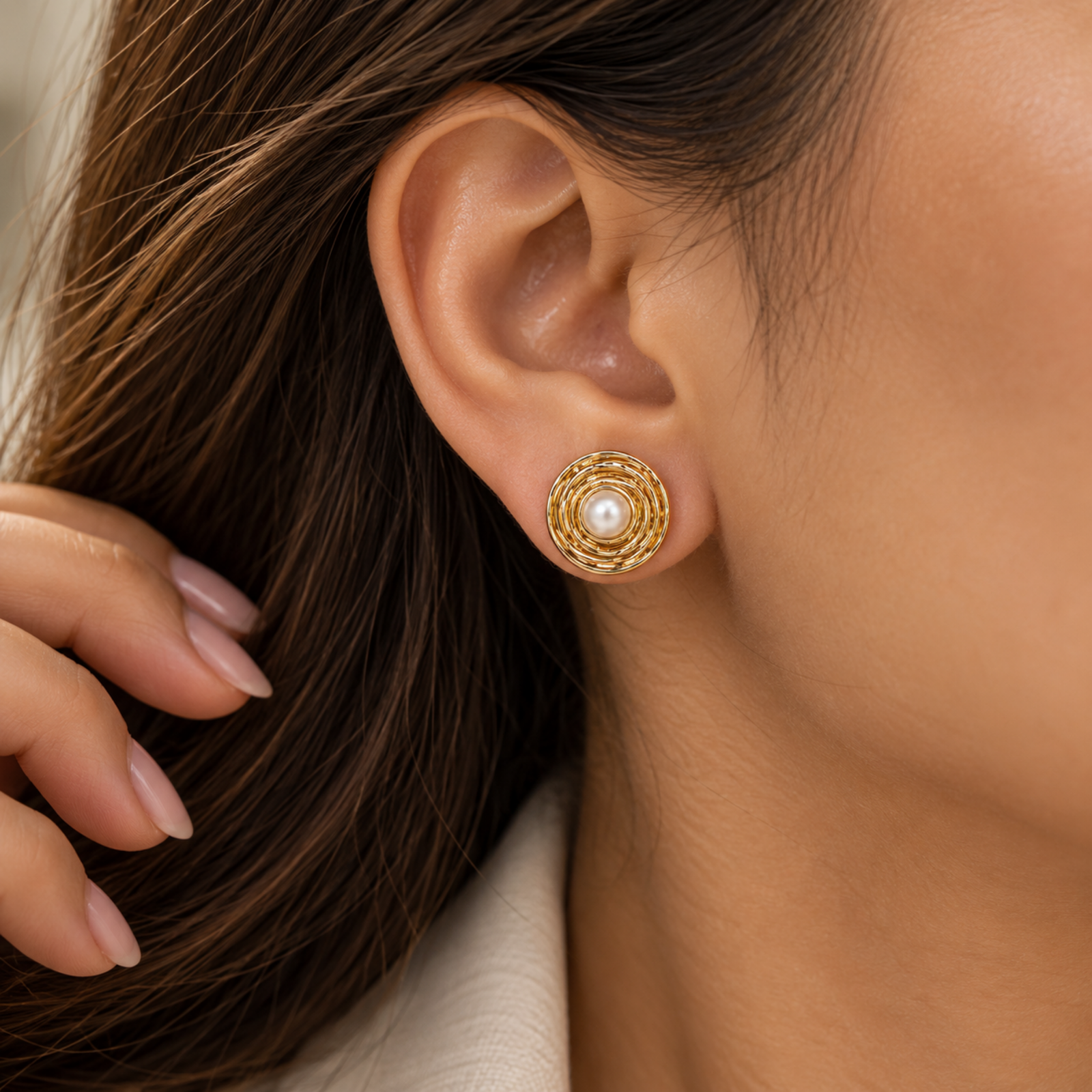 anvor-pearl-stud-earrings.webp ANVOR pearl stud earrings with round pearl-look centres and layered circular detailing