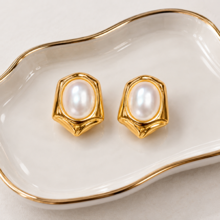 ANVOR pearl stud earrings with oval pearl-look centres and sculpted gold-finish frames