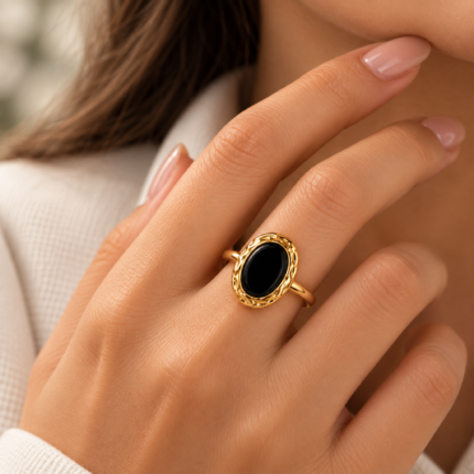 ANVOR black oval ring with ornate gold-tone frame and smooth rounded band