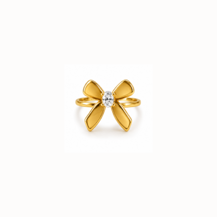 Gold-coloured flower ring with four curved petals surrounding a clear faceted centre stone on a white background.